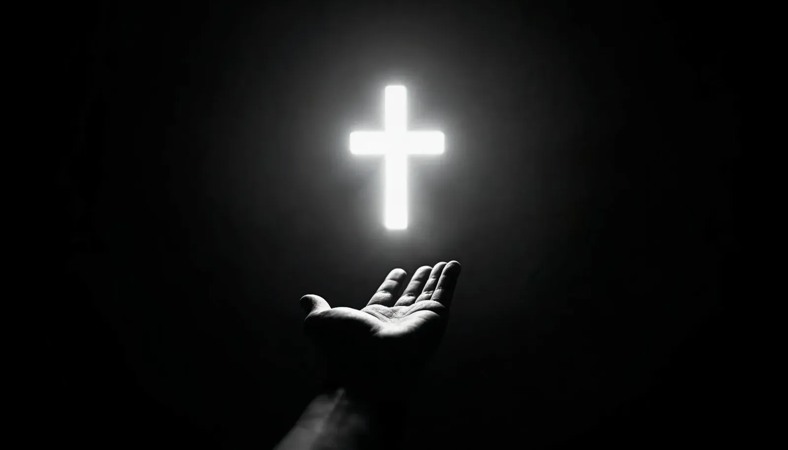 A glowing cross above an open book held in an outstretched hand